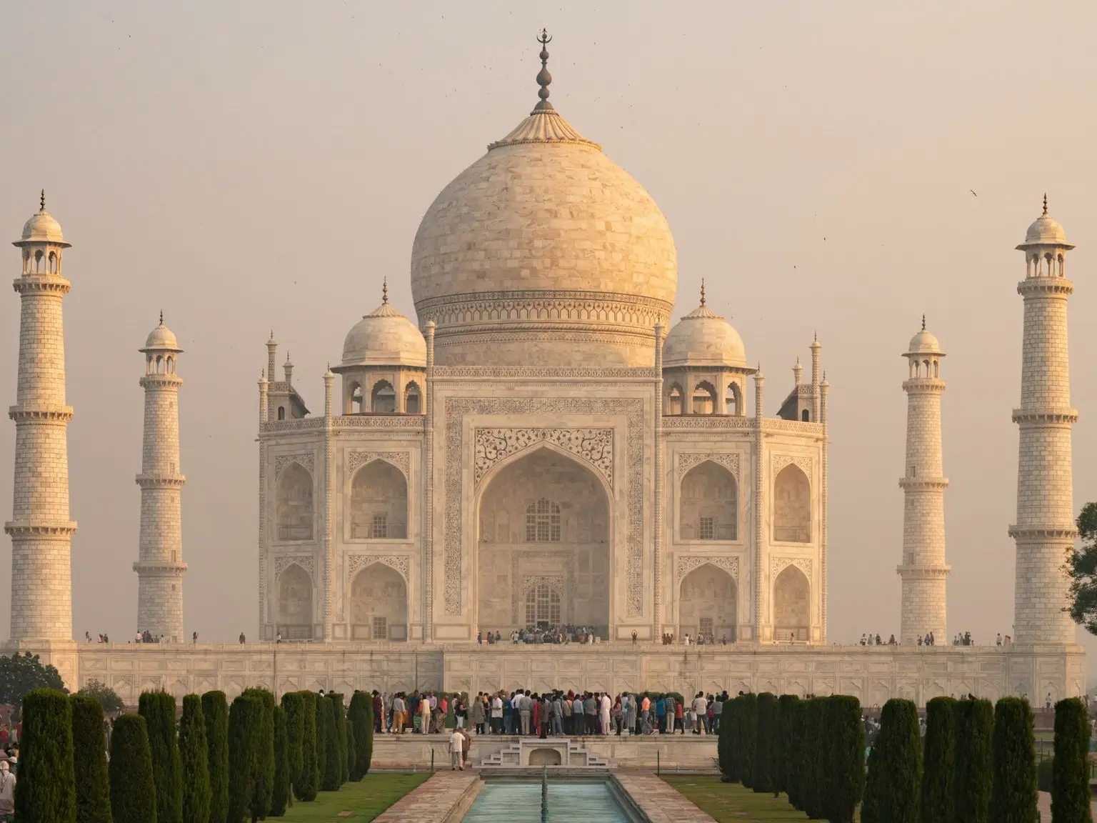 a large white building with a fountain in front of it